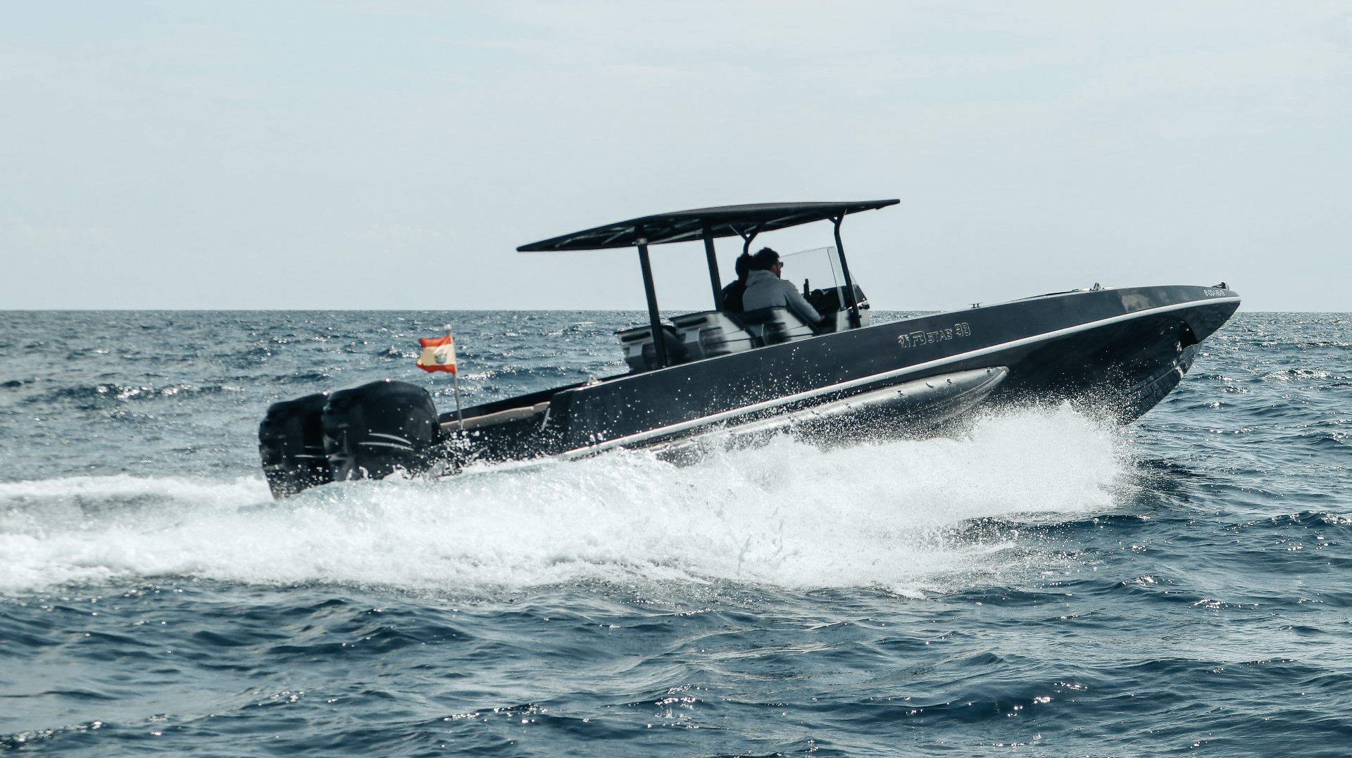 F11 Fabio Buzzi powerboat running beside the INEOS Britannia America’s Cup yacht in Barcelona